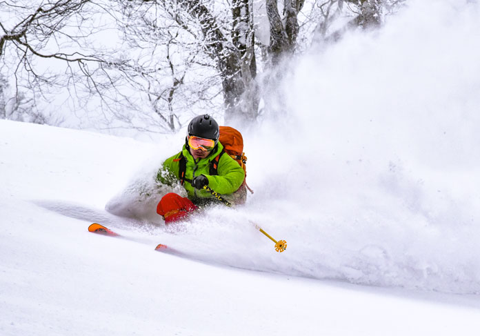slashing deep fresh snow at Ani Ski resort