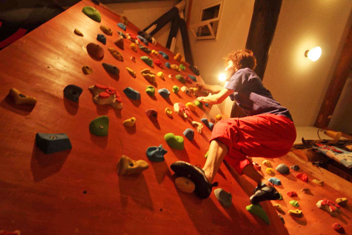 climbing wall in the lounge at Clubman Lodge