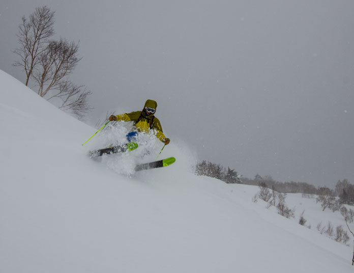 Hachimantai Cat Skiing guide Junya Kuragane charging hard in the powder snow on Mt Chausu
