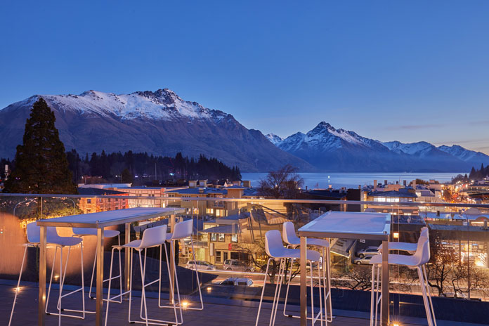 Sunset view over Lake Wakatipu to The Remarkables from mi-pad Queenstown rooftop terrace