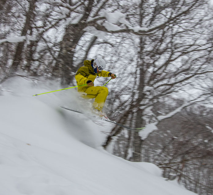 Junya Kurogane pops off a feature in the tree ski zone at Hachimantai Shimokura Ski Resort