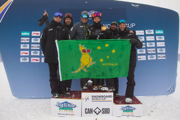 Belle Brockhoff shows the boxing kanagaroo flag on the podium at Big White World Cup Boarder Cross