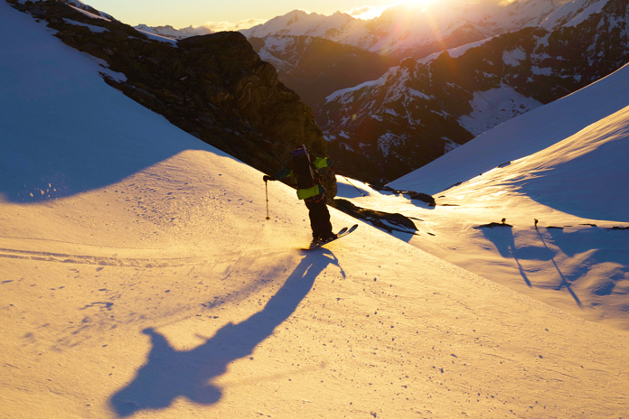 Craig Murray skiing down Mt Aspiring toward Bevan Col at sunset