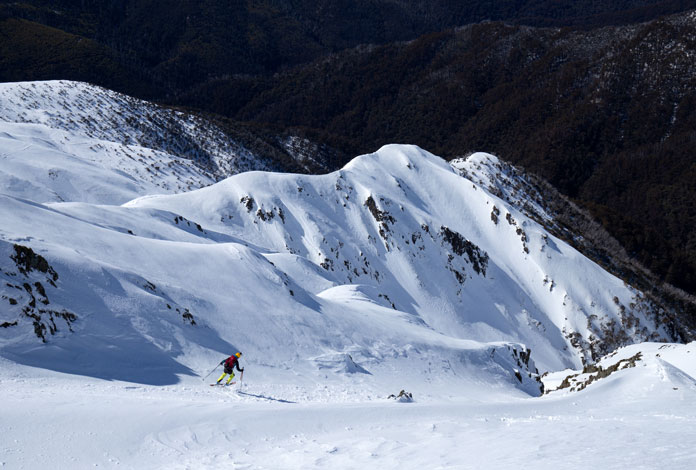 Skier dropping into Headwall at Mt Feathertop