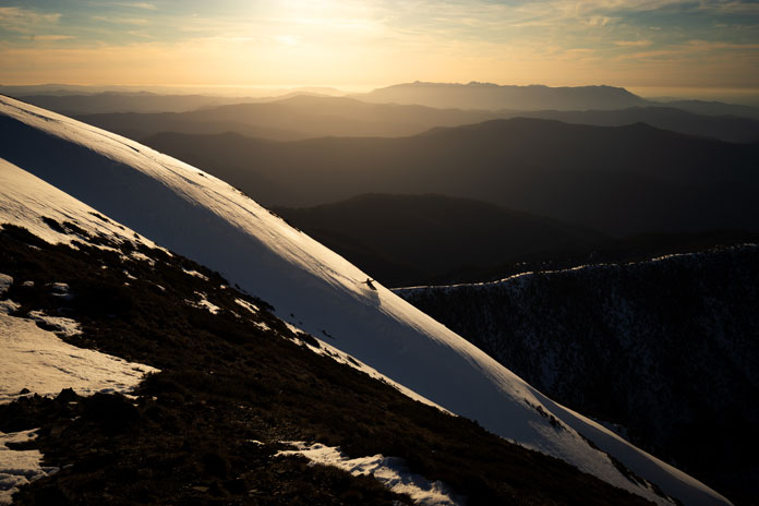 Snowboarder on Mt Feathertop's North Face at dusk