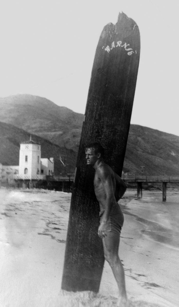 Warren Miller surfing at Malibu Pier 1947