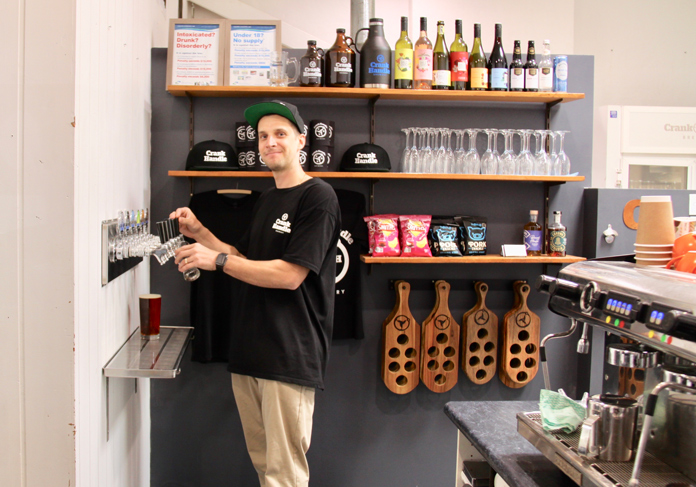 Craig King pours a beer at his Crank Handle Brewing brewery in Mt Beauty