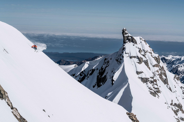 Sam Smoothy skiing a line on Mt Tasman with a view to the West Coast 