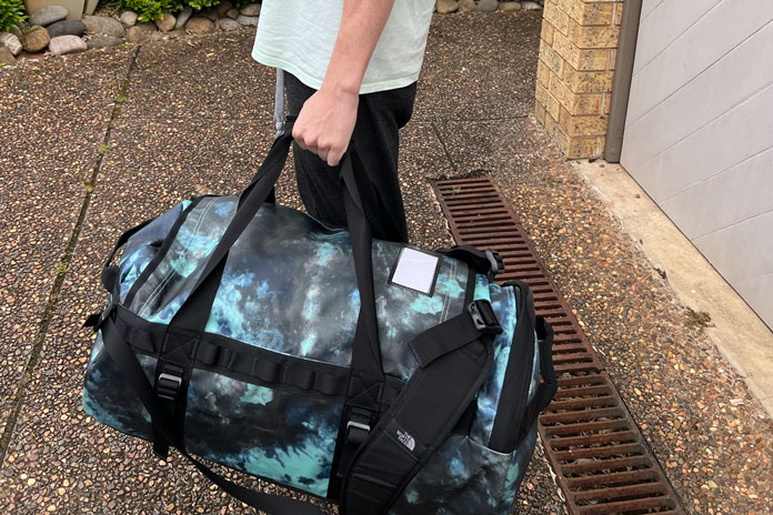 TNF Base Camp duffel over hand carry mode