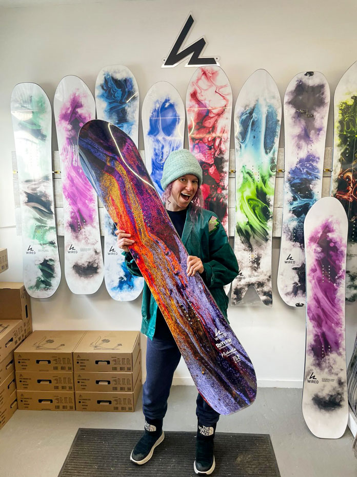 Michaela Davis-Meehan showing off her signature board at the Wired Snowboards factory in Vancouver